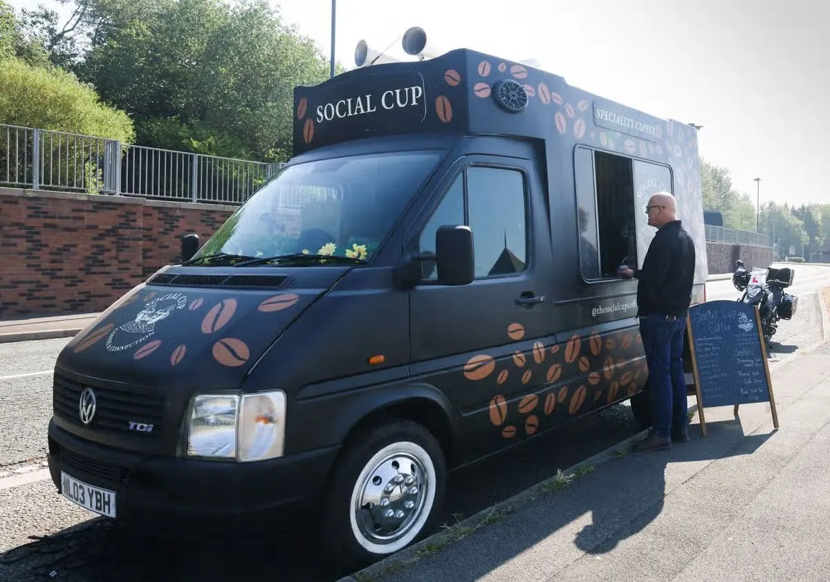 The Social Cup coffee van set up at a pitch with its menu board out